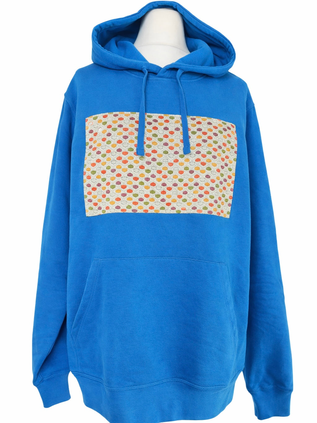 Bright blue unisex hoodie featuring a rectangular panel of upcycled kimono fabric across the chest in a multicoloured geometric dot pattern, with matching blue drawstrings and a front kangaroo pocket.