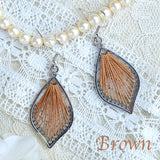 One color mandala design threaded earrings.